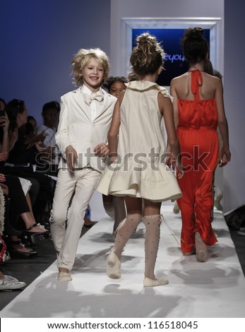 NEW YORK - OCTOBER 21: Kids walk runway for petite Parade show by Bonnie Young during kids fashion week sponsored by Vogue Bambini at Industria Supertudio on October 21, 2012 in New York City