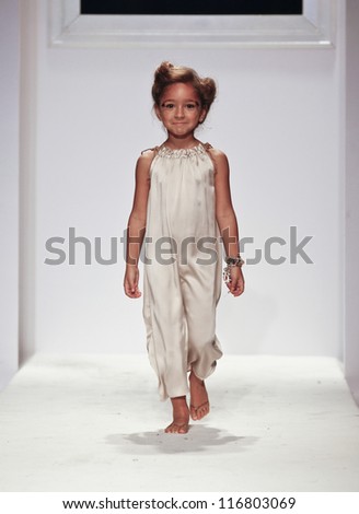 NEW YORK - OCTOBER 21: Girl walks runway for petite Parade show Pale Cloud by Marion Reynolds during kids fashion week sponsored by Vogue Bambini at Industria Superstudio on Oct 21, 2012 in New York