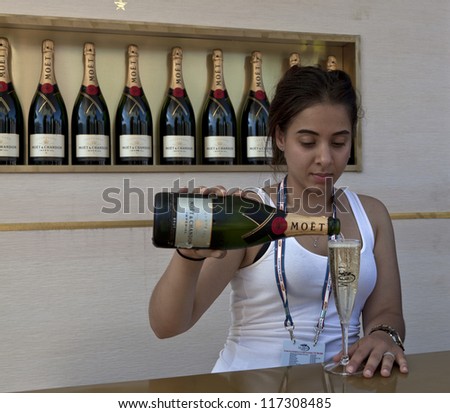 NEW YORK - AUGUST 28: Bartender serves Moet & Chandon flute of champagne at US Open tennis tournament on August 28, 2012 in Flushing Meadows New York