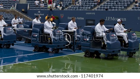 NEW YORK - AUGUST 27: Crew members clean the Ash Stadium court after the rain during 1st day of US Open Tennis Championship on August 27, 2012 in Flushing Meadows in New York City