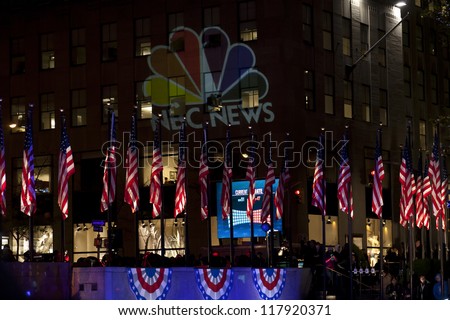 NEW YORK - NOVEMBER 06: American flags & NBS NEWS logo illuminated on 2012 Election day Presidential election on Rockefeller plaza on democracy Plaza sponsored by Microsoft on November 06, 2012 in NYC