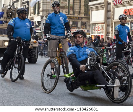 NEW YORK - NOVEMBER 11: Achilles freedom team of wounded veterans ride special bicycles at Veteran\'s Day Parade along 5th Avenue on November 11, 2012 in New York City