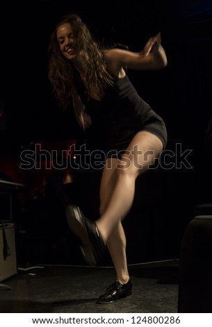 NEW YORK - JANUARY 12: Michelle Dorrance tap dancer performs with Celebrate Great Women of Blues & Jazz band on stage as part of NYC Winter Jazz Festival at Le Poisson Rouge on January 12, 2013 in NYC