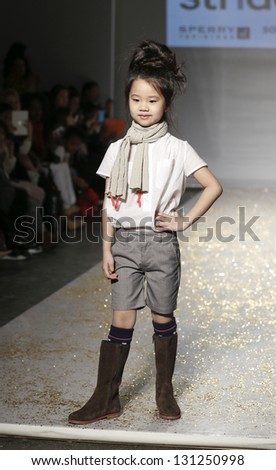 NEW YORK - MARCH 10: Girl model walks runway for petite Parade show by Stride Rite during kids fashion week sponsored by Vogue Bambini at Industria Superstudio on March 10, 2013 in New York City