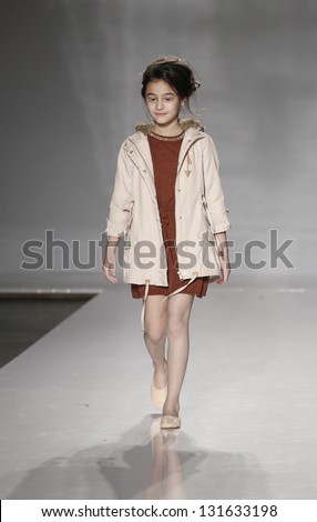 NEW YORK - MARCH 10: Girl model walks runway for petite Parade show by Pale Cloud during kids fashion week sponsored by Vogue Bambini at Industria Superstudio on March 10, 2013 in New York City