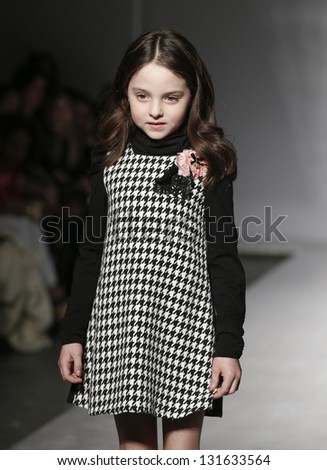 NEW YORK - MARCH 10: Girl model walks runway for petite Parade show by Miss Bluemarine during kids fashion week sponsored by Vogue Bambini at Industria Superstudio on March 10, 2013 in New York City