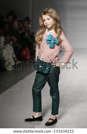 NEW YORK - MARCH 10: Girl model walks runway for petite Parade show by Miss Bluemarine during kids fashion week sponsored by Vogue Bambini at Industria Superstudio on March 10, 2013 in New York City