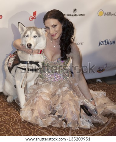 NEW YORK - APRIL 06: Caroline Loevner and dog attend the 27th Annual Night Of A Thousand Gowns at the Hilton New York on April 6, 2013 in New York City
