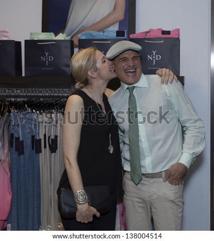 NEW YORK - MAY 8: Actress Kelly Rutherford bites ear of celebrity stylist Phillip Bloch attend opening NYDJ shop at Bloomingdale\'s on May 8, 2013 in New York City.