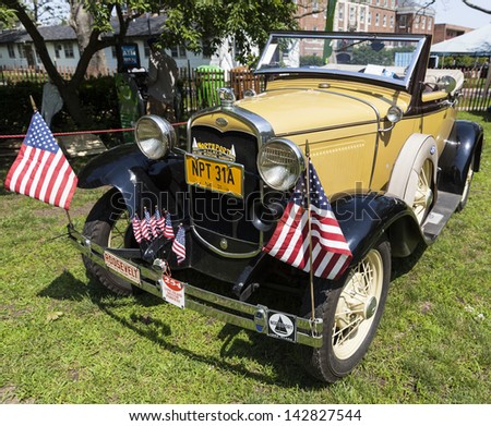 NEW YORK - JUNE 15: Antique Ford car on display during 8th annual Jazz Age lawn party by Michael Arenella & the Dreamland Orchestra on Governors Island on June 15, 2013 in New York City