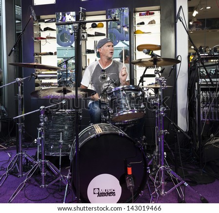 NEW YORK - JUNE 20: Andrew W. K. drums for 24 hours to break world record at Times Square Oakley flagship store on June 20, 2013 in New York City