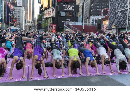 NEW YORK - JUNE 21: Atmosphere during yoga performance sponsored by Athleta to celebrate solstice on Times Square on June 21, 2013 in New York