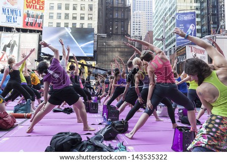 NEW YORK - JUNE 21: Atmosphere during yoga performance sponsored by Athleta to celebrate solstice on Times Square on June 21, 2013 in New York