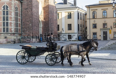 STOCKHOLM - MAY 25: Wedding horse carriage on the street of Stockholm on May 25, 2013 in Stockholm, Sweden