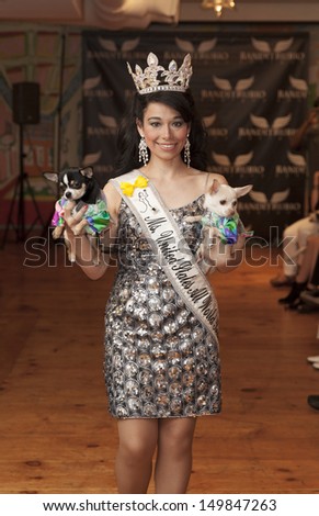 NEW YORK - AUGUST 11: Ms. United States All World Beauties Nency walks dog on runway at Dog fashion show By Bandit-Rubio at Roger Smith Hotel on August 11, 2013 in New York City