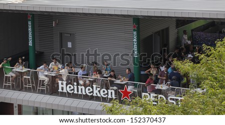 NEW YORK - AUGUST 31: People enjoy Heineken beer at Red Star restaurant on the ground of USTA Billie Jean King Nation Tennis Center during US Open 2013 on August 31, 2013 in Queens New York