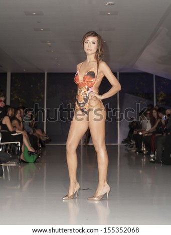 NEW YORK - SEPTEMBER 21: Model walks runway during Expo Latino Show for Doll Closet collection by Dolly Cardona at Museum of Moving Image on September 21, 2013 in New York