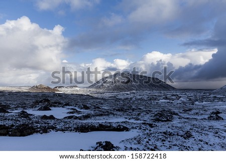 Barren landscape in late spring in Iceland with dormant volcano