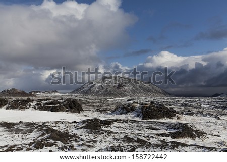 Barren landscape in late spring in Iceland with dormant volcano