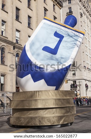 NEW YORK - NOVEMBER 28: First time ever Trixie\'s Dreidel ballon is flown because Hanukkah coincides with Thanksgiving at the 87th Annual Macy\'s Thanksgiving Day Parade on November 28, 2013 in NYC