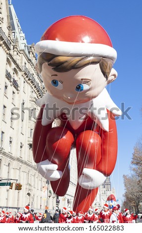 NEW YORK - NOVEMBER 28: Elf on the Shelf balloon is flown low because of weather condition at the 87th Annual Macy\'s Thanksgiving Day Parade on November 28, 2013 in New York City.
