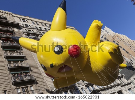 NEW YORK - NOVEMBER 28: Pokemon Pikachu balloon is flown low because of weather condition at the 87th Annual Macy\'s Thanksgiving Day Parade on November 28, 2013 in New York City.
