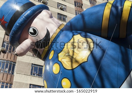 NEW YORK - NOVEMBER 28: Harold the Policeman balloon is flown low because of weather condition at the 87th Annual Macy\'s Thanksgiving Day Parade on November 28, 2013 in New York City.
