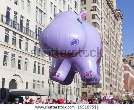 NEW YORK - NOVEMBER 28: Happy Hippo balloon is flown low because of weather condition at the 87th Annual Macy's Thanksgiving Day Parade on November 28, 2013 in New York City.