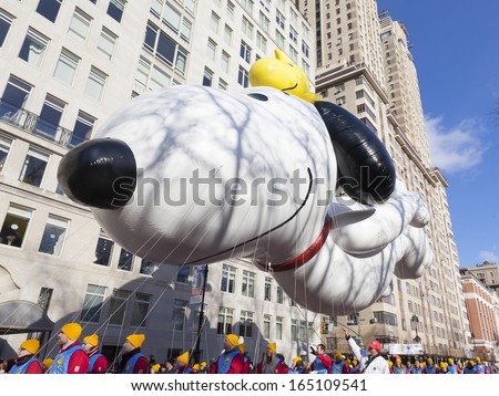 NEW YORK - NOVEMBER 28: Snoopy and Woodstock balloon is flown low because of weather condition at the 87th Annual Macy's Thanksgiving Day Parade on November 28, 2013 in New York City.