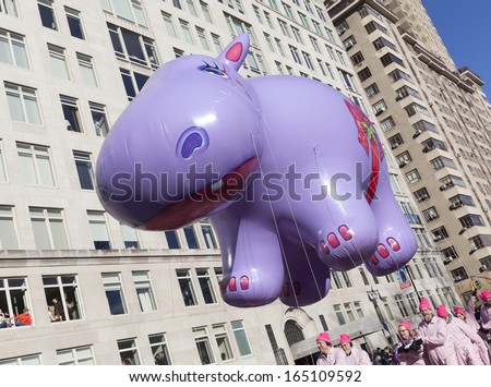 NEW YORK - NOVEMBER 28: Happy Hippo balloon is flown low because of weather condition at the 87th Annual Macy\'s Thanksgiving Day Parade on November 28, 2013 in New York City.