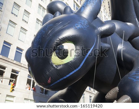 NEW YORK - NOVEMBER 28: Toothless How to train your dragon balloon is flown low because of weather condition at the 87th Annual Macy\'s Thanksgiving Day Parade on November 28, 2013 in New York City.