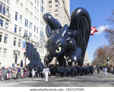 NEW YORK - NOVEMBER 28: Toothless How to train your dragon balloon is flown low because of weather condition at the 87th Annual Macy\'s Thanksgiving Day Parade on November 28, 2013 in New York City.