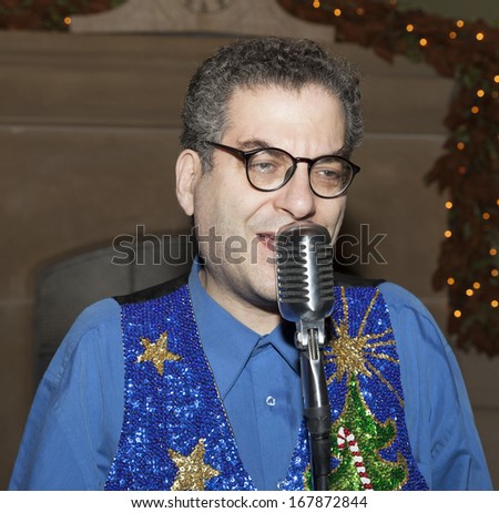 NEW YORK - DECEMBER 17: Michael Musto performs at annual toy drive benefit hosted by Susanne Bartsch and David Barton on December 17, 2013 in New York City.
