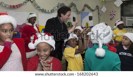 NEW YORK - DEC 20: Adrien Brody & kids attend Action Center Post-Sandy Holiday Party at The Action Center presented by Bulgari & Save the Children on Dec 20, 2013 in Far Rockaway of Queens in NYC