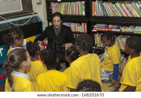 NEW YORK - DEC 20: Adrien Brody shows magic tricks at Action Center Post-Sandy Holiday Party at The Action Center presented by Bulgari & Save the Children on Dec 20, 2013 in Far Rockaway Queens in NYC