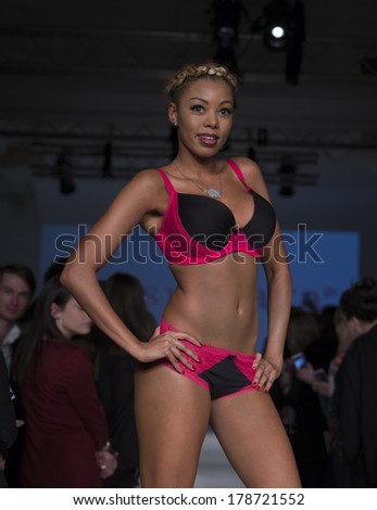 NEW YORK, NY - FEBRUARY 24, 2014: Model walks runway for Lingerie fashion night IN show by Passionata during CurveExpo at Tribeca Skyline Studios