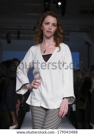 NEW YORK, NY - FEBRUARY 24, 2014: Model walks runway for Lingerie fashion night IN show by Pluto on the Moon during CurveExpo at Tribeca Skyline Studios