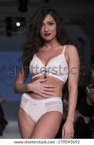 NEW YORK, NY - FEBRUARY 24, 2014: Model walks runway for Lingerie fashion night IN show by Cake Lingerie during CurveExpo at Tribeca Skyline Studios