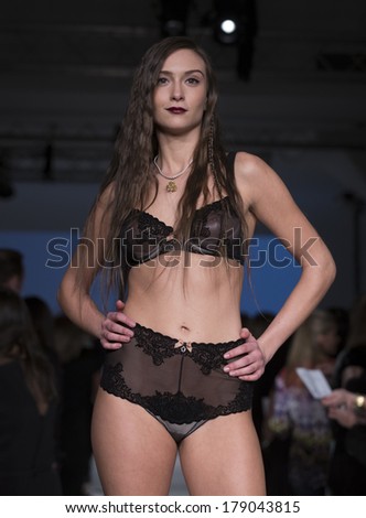 NEW YORK, NY - FEBRUARY 24, 2014: Model walks runway for Lingerie fashion night IN show by Ajour during CurveExpo at Tribeca Skyline Studios
