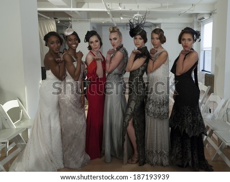 NEW YORK, NY - APRIL 13, 2014: Models show off evening gown for Junko Yoshioka runway show during bridal week at Studio Arte on 37th Street
