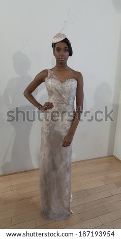NEW YORK, NY - APRIL 13, 2014: Model shows off evening gown and hat for Junko Yoshioka runway show during bridal week at Studio Arte on 37th Street