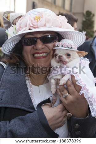 New York, USA - April 20, 2014: Unidentified Lady with the dog partakes and shows off her hats at the Easter Bonnet Parade on 5th Avenue