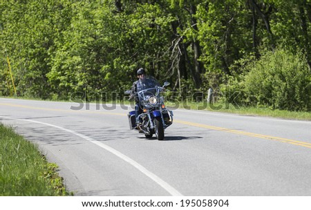 Tuxedo, NY USA - MAY 25, 2014: Unidentified member of Shameless Few motorcycle club rides on the road