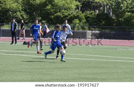 NEW YORK, NY - MAY 31, 2014: South Bronx United 01 team plays against Brooklyn Chernomorets team as part of Cosmopolitan Junior Soccer League Under 12 at Macombs Dam Field the Bronx