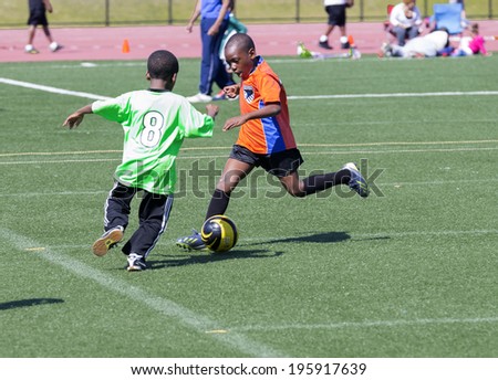NEW YORK, NY - MAY 31, 2014: Bronx United Soccer boys soccer teams plays at Macombs Dam Field  the Bronx