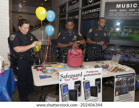New York, NY - July 02, 2014: NYPD officers from Transit precinct meet and help commuters at MTA 42nd street station