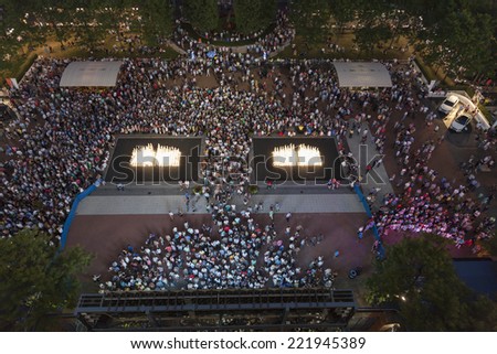 NEW YORK, NY - SEPTEMBER 3, 2014: View of plaza with crowd in front of Arthur Ash stadium during night session at US Open championship in Flushing Meadows USTA Tennis Center