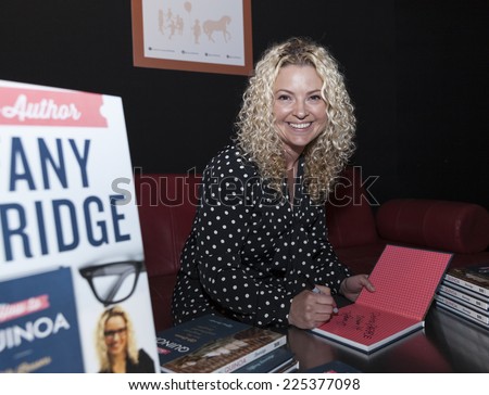 New York, NY - October 18, 2014: Author Tiffany Beveridge signs her book during PetiteParade Kids Fashion week at Bath House Studios