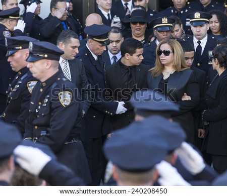 NEW YORK, NY - DECEMBER 27, 2014: Maritza Ramos, Justin Ramos and Jared Ramos attend Christ Tabernacle Church for the funeral of slain New York City Police Officer Rafael Ramos