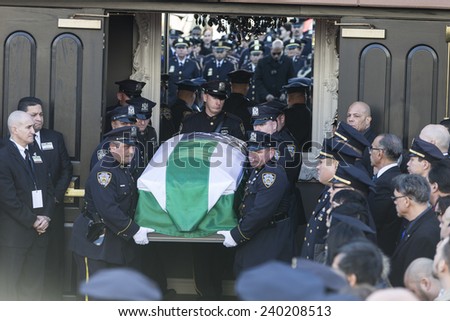 NEW YORK, NY - DECEMBER 27, 2014: Casket of murdered New York Police Officer Rafael Ramos is carried out of Christ Tabernacle church in Queens
